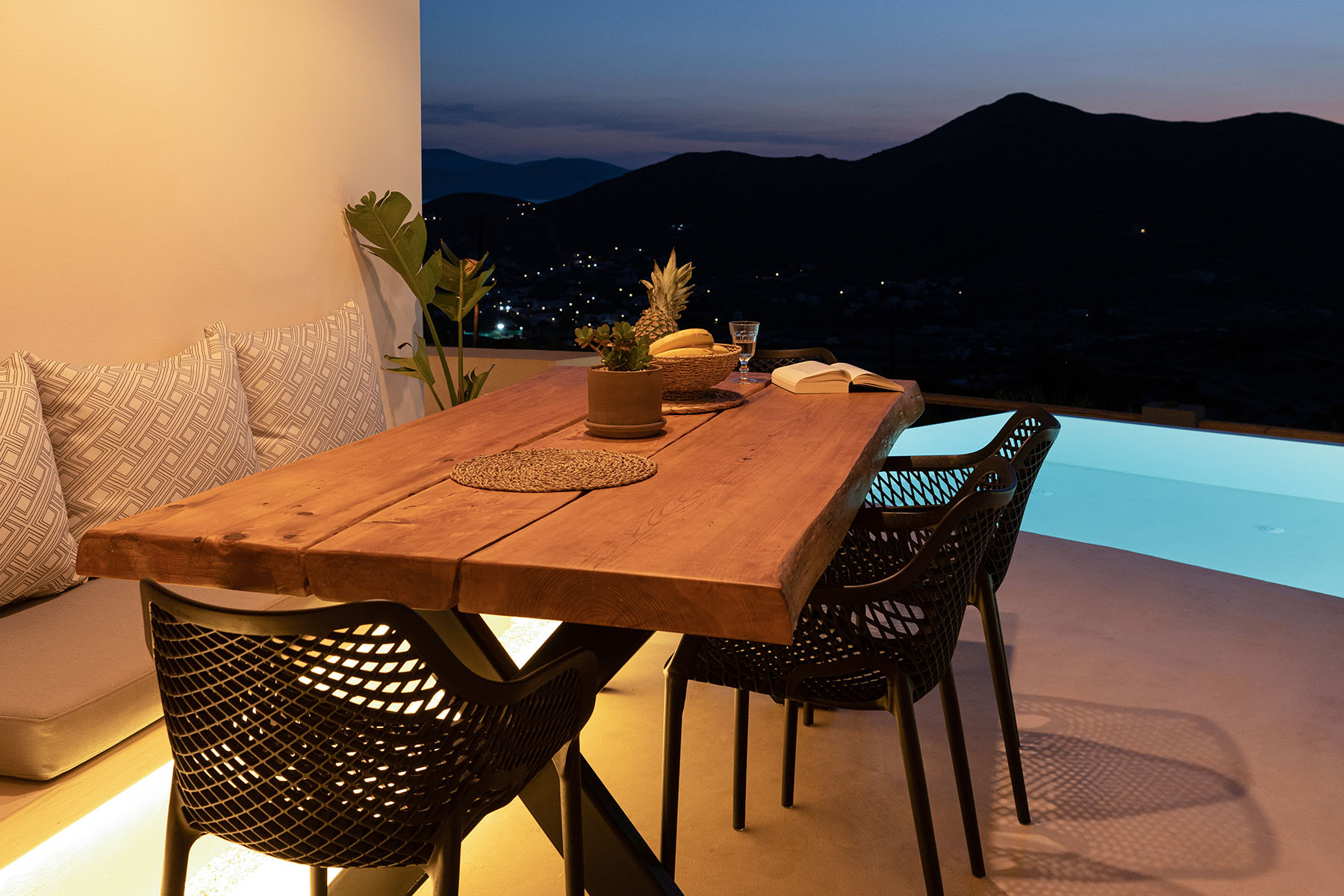 Outdoor dining table at dusk on a villa terrace in Ios