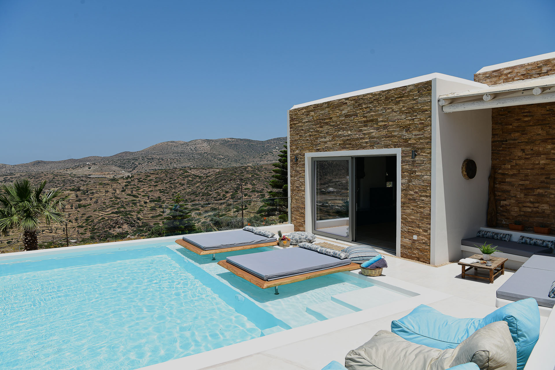 Private pool with sun loungers and views over the hills and sea of Ios